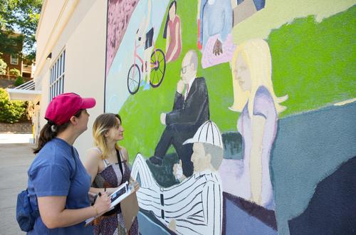 two white women study mural